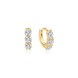 A pair of gold huggie hoop earrings with three clear round-cut stones on each earring, displayed on a clean white background.