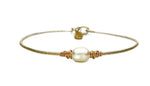 Sterling Silver or 14k Gold Filled band, 14K Gold Filled Wire wrap with Freshwater Pearl. When you wear EGJ Serenity Pearl Bracelet be encourage to remember that sometimes simple is beautiful. We have sterling silver band with 14K Wrap in stock in sizes below. We can order other color band and sizes if needed. 