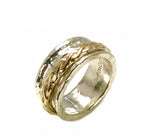 Sterling Silver and 14K Gold Filled. This ring features a hammered Sterling Silver band with and inner captured band of 14K Gold filled. This ring is not only beautiful, it's fun to play with. We have this ring in stock in size 5.00. We can order it in sizes from 5.00 to 10.00. Whole sizes only. 