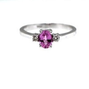 .70 carat Oval Pink Sapphire and .06 carat in Diamonds Ring set in 14 karat white gold. Ring size is 7.00.