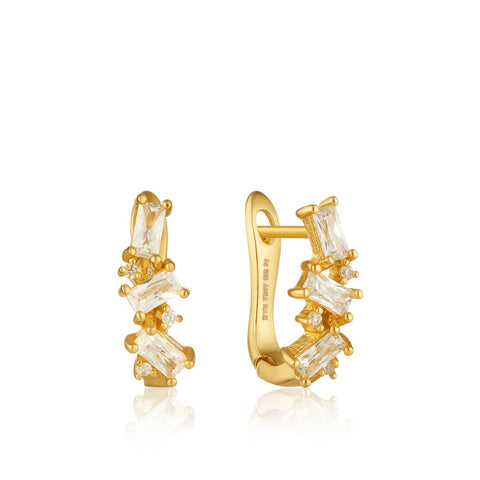 hine from all angles with these sparkling gold huggie earrings. Featuring a cluster of cubic zirconia baguettes, they are this season's must have. The classic baguette jewelry just got a modern makeover with our Glow Getter collection. These statement pieces will let you shine in the spotlight and become timeless favorites.  • Material: 14kt gold on sterling silver • Earring size: 10mm x 12mm • Weight: 1.5g