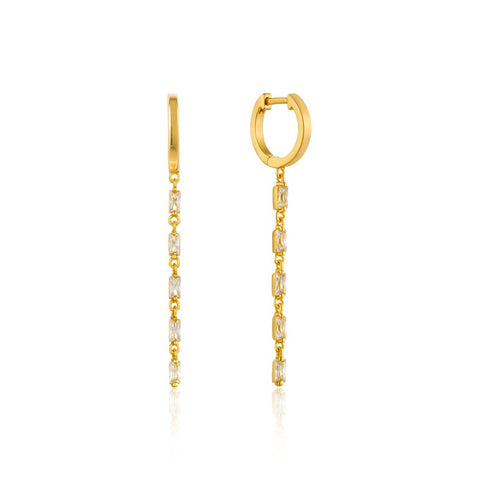Maximize on glamour with these gold drop earrings featuring delicately shimmering cubic zirconia baguettes. The classic baguette jewelry just got a modern makeover with the  Glow Getter collection. These statement pieces will let you shine in the spotlight and become timeless favorites.   • Material: 14kt gold plated on sterling silver • Earring length: 45mm • Weight: 2.2g